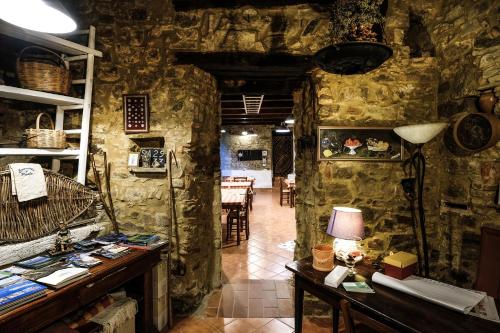 a room with stone walls and a table with a lamp at Antico Convento - Ospitalità Diffusa in Rocca Cilento