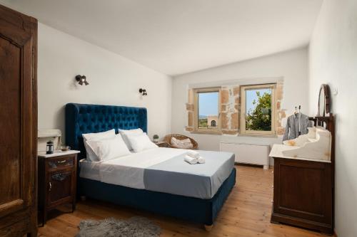 a bedroom with a blue bed and a sink at Mansion D in Galatás