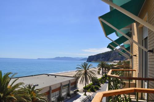 a view of the beach from the balcony of a building at Hotel Boncardo in Finale Ligure