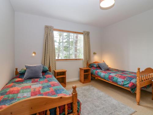 a bedroom with two beds and a window at The Bungalow in Elgin