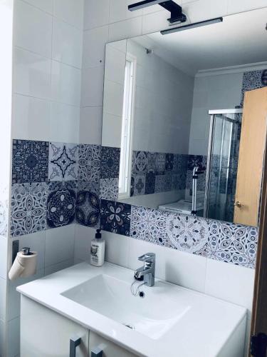 a bathroom with a sink and a mirror at Sunlight Málaga Centro in Málaga