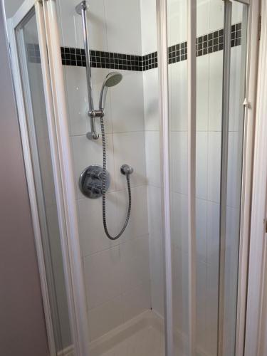 a shower in a bathroom with a glass door at Chapel View in Ballycastle
