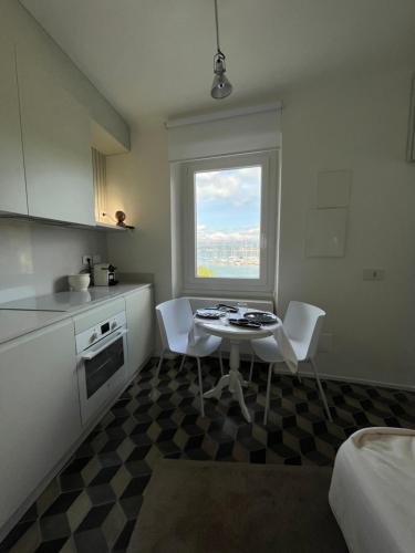 a kitchen with a table and chairs and a window at About Italy Holiday Rooms and Apartments in Portovenere