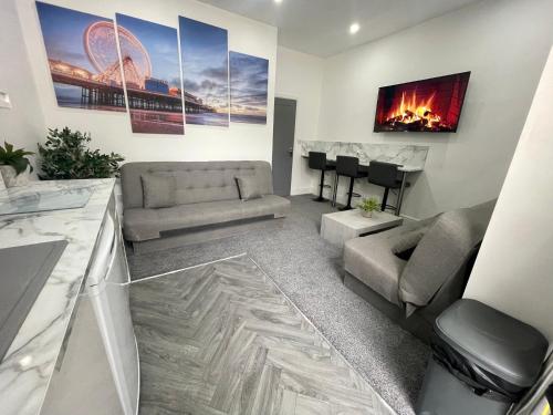 a living room with a couch and a table at Osborne hot tub and jacuzzi suites in Blackpool