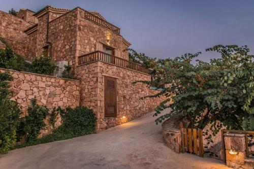 a large stone building with a door on the side at Beyond Villas in Agios Nikitas