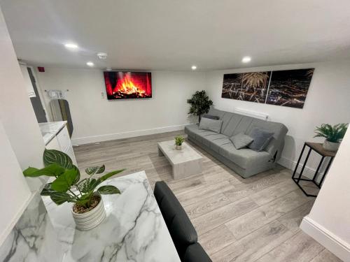 a living room with a couch and a fireplace at Osborne hot tub and jacuzzi suites in Blackpool