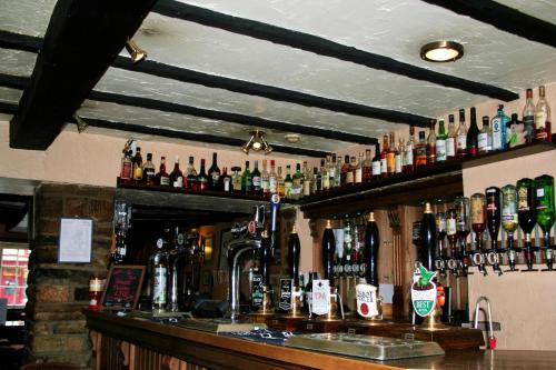 a bar with a lot of bottles of alcohol at George & Dragon Hotel in Kirkbymoorside
