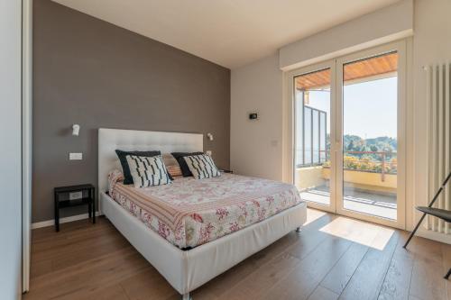 a bedroom with a bed and a large window at Eco del Silenzio in Lerici