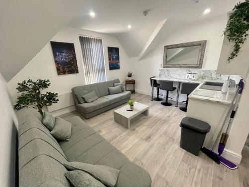 a living room with a couch and a table at Osborne hot tub and jacuzzi suites in Blackpool