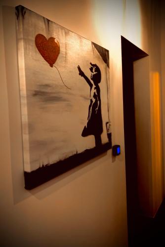 a painting of a woman flying a kite on a wall at Oro Nero Florence in Florence