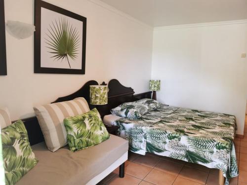 a living room with a bed and a couch at Tropik-Appart - Studio in Sainte-Luce