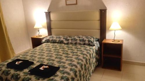 Un pat sau paturi într-o cameră la Complejo Arena Malva