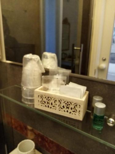a bathroom with a glass counter with towels and a mirror at L'Angelo Blu in La Spezia