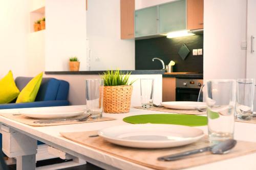 a kitchen with a table with plates and glasses on it at VillaHouse Carnide in Lisbon