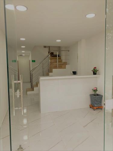 a lobby with a staircase and a glass wall at Buritaca House in Buritaca