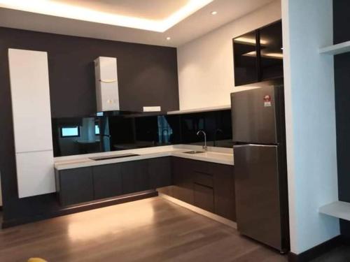 a kitchen with a sink and a refrigerator at Sutera Homestay Vista Bangi with WIFI in Bangi