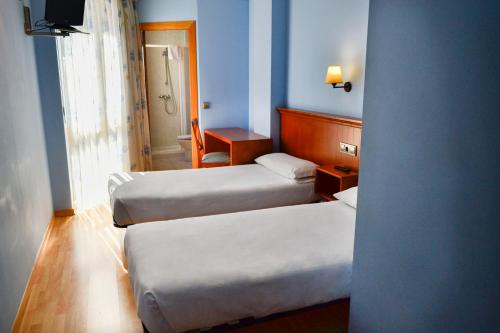 Tempat tidur dalam kamar di Alda Vía de la Plata Rooms