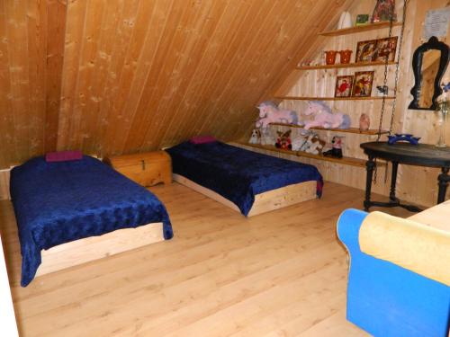 a room with two beds and a table in it at Õuna Puhketalu in Jõgeva