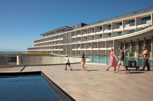 a group of people walking in front of a building at Dreams Bahia Mita Surf and Spa - All Inclusive in Punta Mita