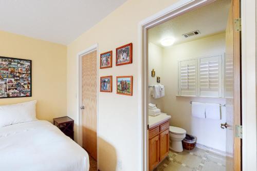 a bedroom with a bed and a toilet and a sink at Alder Lake View Lodge in Bass Lake