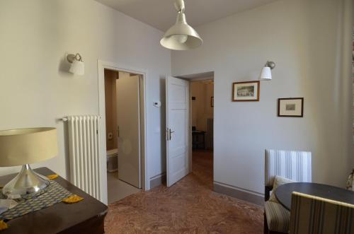 a living room with a table and a lamp at Nobiallum B&B in Menaggio