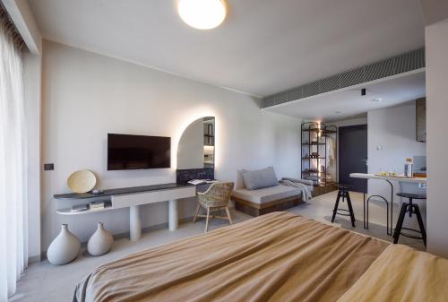 a bedroom with a bed and a living room at ANASSA BUTIK LIVING NIKITI in Nikiti
