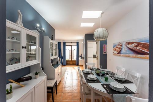 a dining room with a table and chairs at villa del mar puerto del carmen in Puerto del Carmen