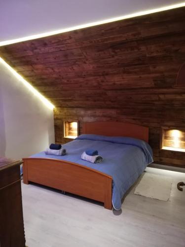 a bedroom with a bed with wooden walls and lights at appartamento Florianca in Tarvisio