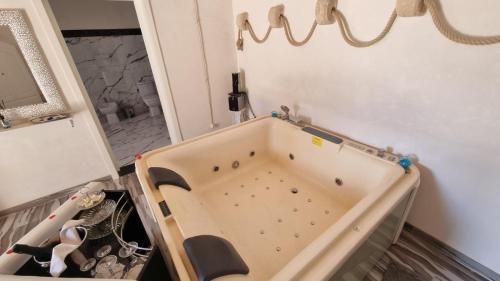 a room with a tub in the corner of a room at Il Casale Suite&Rooms in Burgio