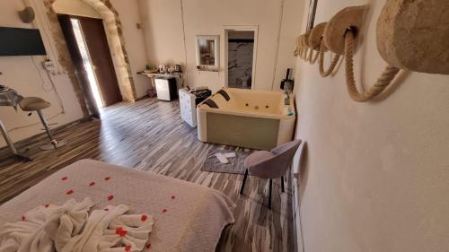 a room with a bed and a table with red hearts on the floor at Il Casale Suite&Rooms in Burgio