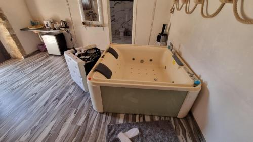 a bath tub sitting on the floor in a room at Il Casale Suite&Rooms in Burgio