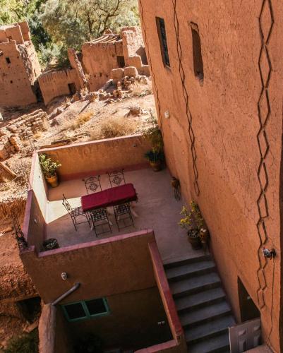 an aerial view of a building with tables and chairs at Kasbah Maison D’hôte Lalla Zahra in Aït Baha