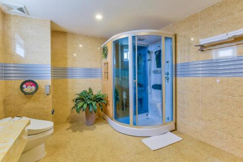 a bathroom with a shower and a toilet in it at Sky Beach D20 Nha Trang in Nha Trang