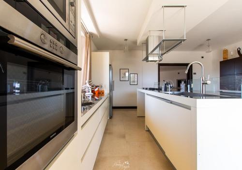 a kitchen with a long counter and a sink at Villa in Langa in Belvedere Langhe