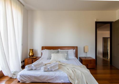 a bedroom with a large bed with white sheets at Villa in Langa in Belvedere Langhe
