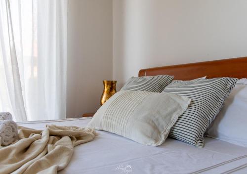 a bed with two pillows and a blanket on it at Villa in Langa in Belvedere Langhe
