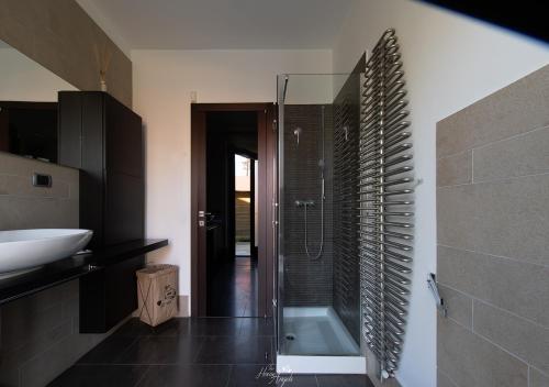 a bathroom with a shower and a sink and a toilet at Villa in Langa in Belvedere Langhe