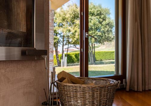a wicker basket sitting in a room with a window at Villa in Langa in Belvedere Langhe