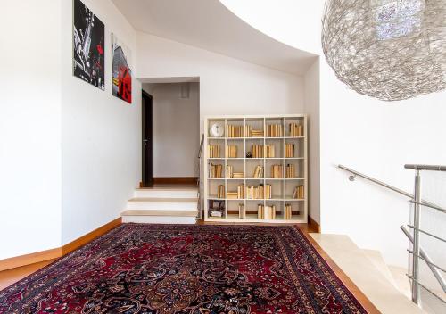 a hallway with a rug and a book shelf at Villa in Langa in Belvedere Langhe