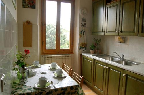 a kitchen with a table and a sink at Casa Martellina - Holiday Home in Bagno a Ripoli