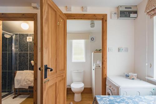 a bathroom with a toilet and a sink at Pheasants Lodge by Bloom Stays in Canterbury