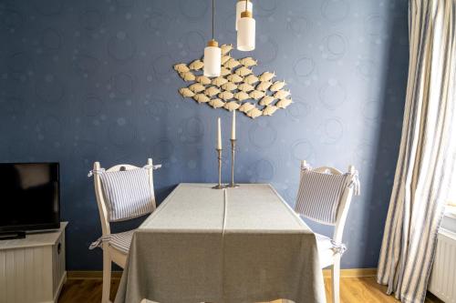 a dining room with a table and two chairs at Alt Wyk in Wyk auf Föhr