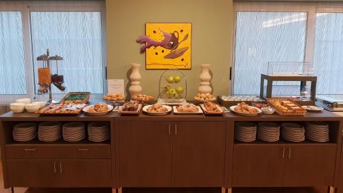 a buffet with many different types of food on it at Hotel Europa Art Caserta in Caserta