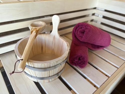 a wooden spoon and a brush on a rack at SPA-Apartment mit Sauna in Ulm-Böfingen in Ulm