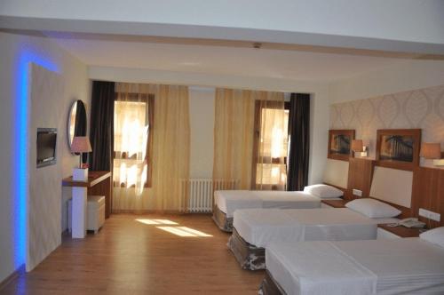 a hotel room with two beds in a room at Hotel Baylan İzmir in Izmir
