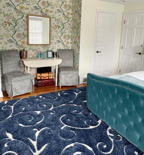 a bedroom with a bed and a table and two chairs at The Homestead in Madison