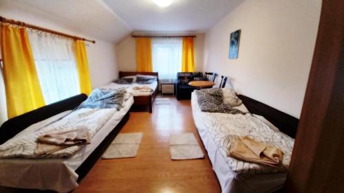 un soggiorno con 2 letti e un divano di Agroturystyka u Joli a Polanica-Zdrój