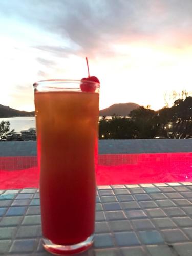 a drink sitting on a table with a cherry on top at Hotel puesta del sol in Valle de Bravo