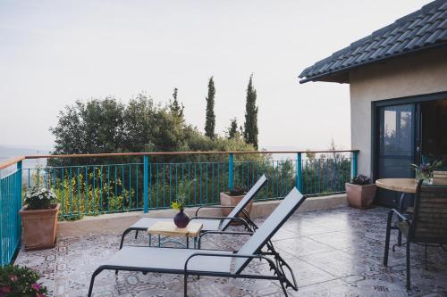 a patio with chairs and tables on a balcony at קטלב kta-love in Kammon