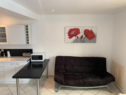 a living room with a couch and a table at Le saint genix in Saint-Genix-sur-Guiers
